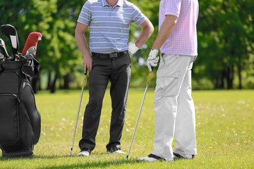 Poster - Young men on golf course in sunny day