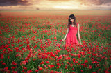 Fototapeta Kuchnia - Beauty woman in a red dress dancing poppy field at sunset, cleanliness and innocence, unity with nature