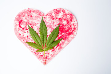 Wall Mural - Marijuana leaf on a red heart shape