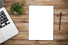 Modern Workplace With Notebook, Blank Paper, Pencil And Little Tree Copy Space On Wood Background. Top View. Flat Lay Style.