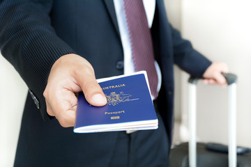 Wall Mural - Businessman giving passport with boarding  pass inside