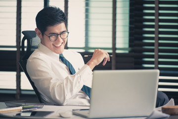 Businessman working at office with laptop,Toned image.