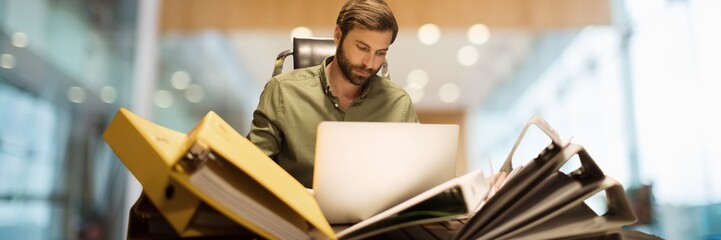 Fototapete - Man with files and folders with blurred background