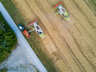 Wall Mural - Aerial view of combine harvester unloading