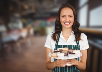 Poster - Cafe owner holding cupcakes against blurry cafe