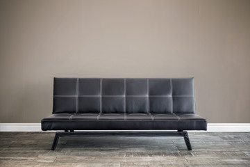 Front view of black leather sofa.