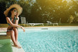 © ZoomTeam - Model Posing Next to Swimming Pool in garden