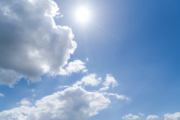 cloudscape with blue sky and sun for backgrounds