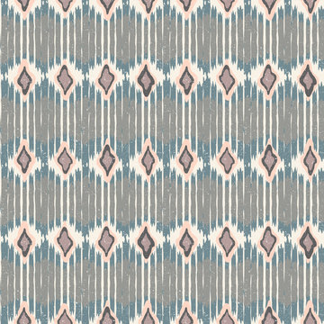 Vector seamless geometric pattern with chevron stripes in ikat fabric style.