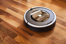 Robotic Vacuum Cleaner On Laminate Wood Floor Smart Cleaning Technology