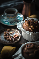 Wall Mural - Banana cupcakes with nuts on the wooden table vertical