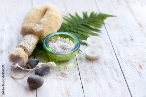 Spa Setting with Washcloth,Natural Soap and Sea Salt with Fern on white wooden b Poster