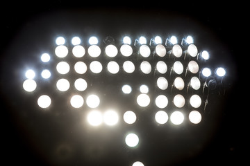 Wall Mural - stadium lights reflectors against black background