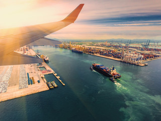 Wall Mural - container,container ship in import export and business logistic.By crane , Trade Port , Shipping.Tugboat assisting cargo to harbor.Aerial view.airfreight.transportation.