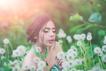 Wall Mural - girl with fashionable makeup and beads in green leaves