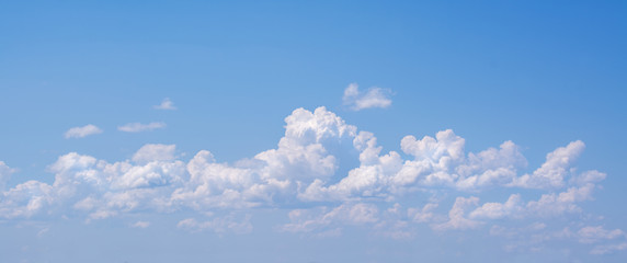white curly clouds in a blue sky. sky background