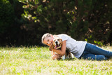 Fototapeta Kosmos - Girl plays with a dog 