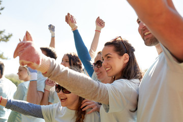 Wall Mural - group of volunteers celebrating success in park