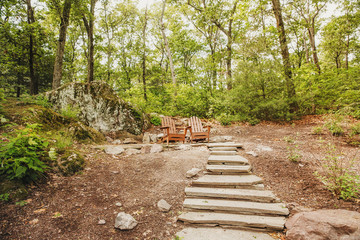 Two wooden armchairs in the park. stone steps at the place of outdoor recreation