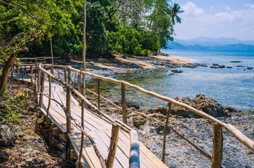 Wall Mural - Bamboo path on tropical beach with palm trees, El Nido, Palawan, Philippines