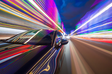 Wall Mural - Blurred urban look from fast driving car to back side and driver at night. Longexposure shot.