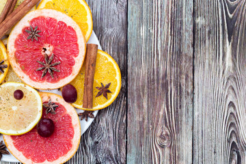 slices of oranges, lemons and grapefruits on vintage white table. Citrus fruit background. healthy eating with natural vitamins. Top view with copy space