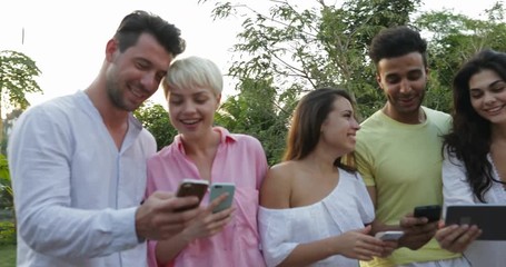 Sticker - Group Of People Talking Holding Cell Smart Phones On Terrace Over Sunset Landscape, Young People Communicating Messaging Online Outdoors Slow Motion 60