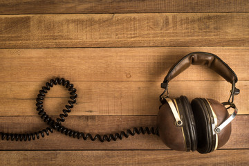 Headphones on wooden background