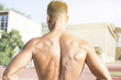 © Addoro - Close up shot of a man's back. Handsome middle aged man working out on a running track. Healthy adult man from behind.