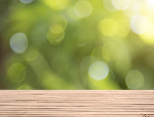 Wall Mural - Wood table top on green bokeh background for product display montage.