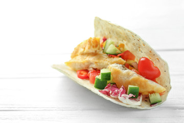 Sticker - Tasty fish taco on white wooden background