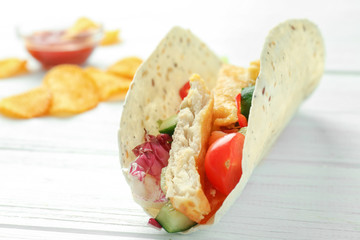 Sticker - Tasty fish taco with chips on white wooden background