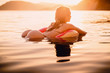 © artifirsov - Perfect woman swimming in sea at sunset. Slim lady relaxing on her holidays at ocean