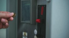 Man Dropping Coin Into Vending Machine, Paying For Something. Put Money Into A Slot. Financial Operation. Close Up View