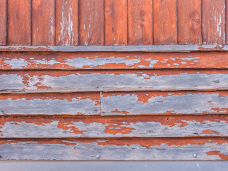 Wood wall is decayed by rain and sun.