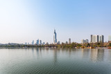 Fototapeta  - City Skyline By River Against Sky in city of China.