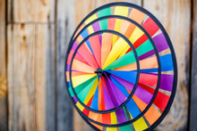 Colorful Toy Pinwheel On Wooden Background Wall