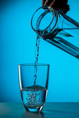 Wall Mural - Man pours water from glass