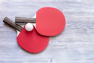 Wall Mural - Red racket for ping pong ball wooden background top view