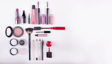 Colorful Frame With Various Makeup Products On A White Background. Close Up Look At The Mascara Brushes And Nail Polish Over A White Background.