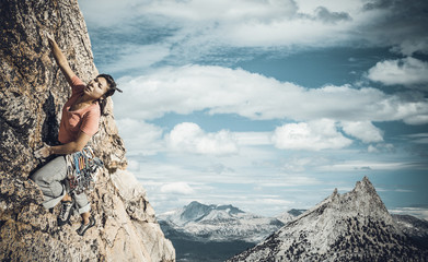 Wall Mural - Rock climber clinging to a cliff.