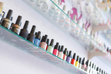Colorful Manicure Nail Polish Bottle Collection Set On Shelf