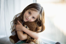 Portrait Of A Beautiful Girl With A Brown Toy Bear