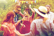 © Syda Productions - happy friends dancing at summer party in garden