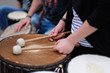 A drummer with chopsticks behind a percussion set at a concert of percussion music.