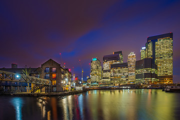 Wall Mural - London, England - The skyscrapers of Canary Wharf financial district and residential buildings at the docklands of London by night