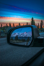 Reflection In Rear View Mirror Of Mountain Sunset