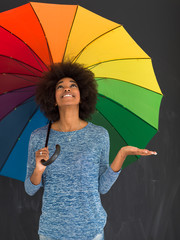 Poster - african american woman holding a colorful umbrella