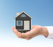 © denphumi - Mortgage concept by house  in hand