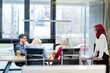 © Myvisuals - Back view of co-workers writing documents using laptops at workplace in office. Copyspace.